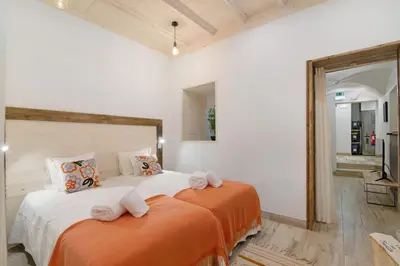 a bedroom with a large bed with towels on it at Casa na Travessa 2 in Faro
