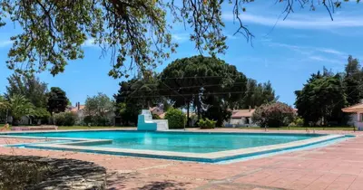 a swimming pool in a yard with trees at Poolside Villa Sereno in Albufeira