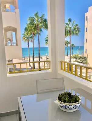 a dining room with a table and a view of the beach at Amazing Ocean View Apt Steps from the Beach in Quarteira