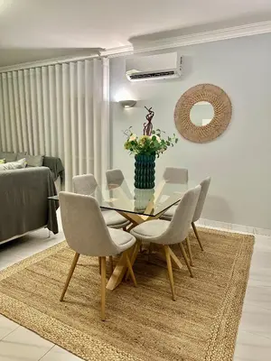 a dining room with a glass table and chairs at Amazing Ocean View Apt Steps from the Beach in Quarteira