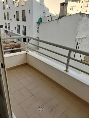 a balcony with a railing and a tile floor at T2 Infante AC wifi Garagem 50m Praia in Quarteira