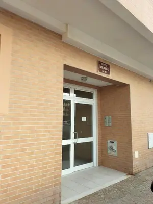 a entrance to a building with a glass door at T2 Infante AC wifi Garagem 50m Praia in Quarteira