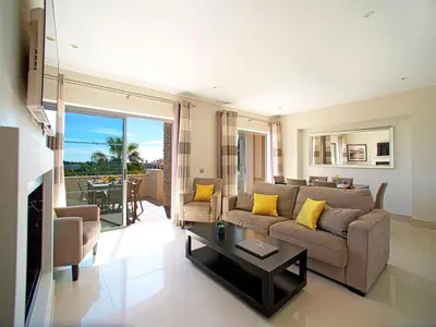 a balcony with a table and chairs and a swimming pool at Apartment Pine Hills Cristal by Interhome in Vilamoura