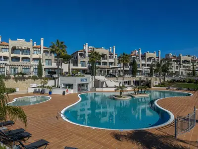a view of a beach with rocks and the ocean at Apartment Pine Hills Cristal by Interhome in Vilamoura