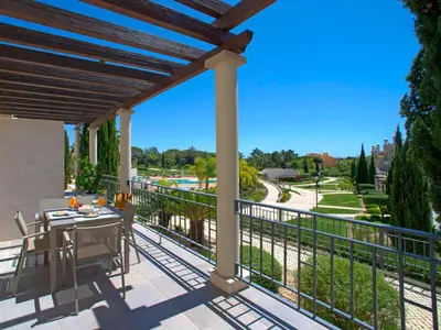 a patio with a bench and a view of a house at Apartment Pine Hills Ambar by Interhome in Vilamoura