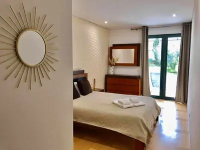 a bedroom with a bed and a mirror on the wall at Marina Vilamoura - Aquamar 009 - By Vilamoura Sun in Loulé