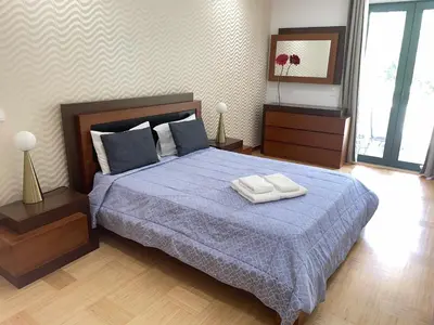 a bedroom with a bed with two towels on it at Marina Vilamoura - Aquamar 009 - By Vilamoura Sun in Loulé