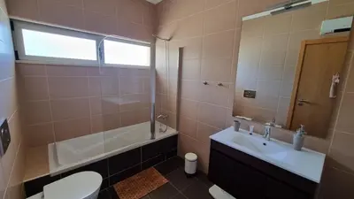 a bathroom with a toilet and a sink and a shower at Splendide Appartement Standing Casa Biblos en Famille ou en Amoureux in Albufeira
