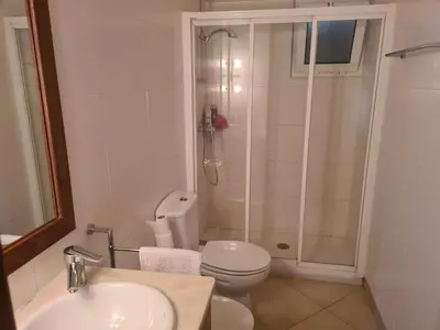 a bathroom with a shower and a toilet and a sink at Vilamoura Alecrim in Vilamoura