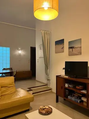 a living room with a couch and a television at Vilamoura Alecrim in Vilamoura