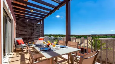 a patio with a table and chairs on a balcony at Greice Homes-2 bedroom penthouse Vilamoura in Quarteira