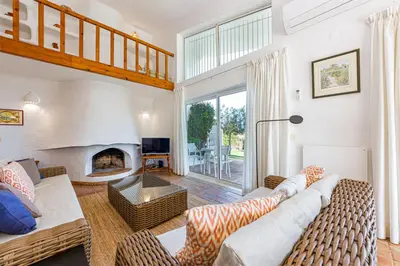 a living room with a couch and a fireplace at Villa Bolota in Albufeira