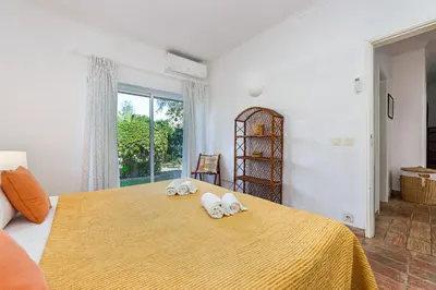 a bedroom with a bed with two towels on it at Villa Bolota in Albufeira
