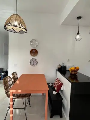 a kitchen with a table and a dining room at Vilamoura Neptuno Apartment in Vilamoura