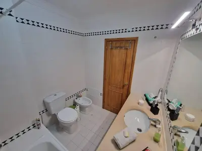 a bathroom with a toilet and a sink and a toilet istg at Charming Beachside Apartment- The Perfect Getaway! in Albufeira