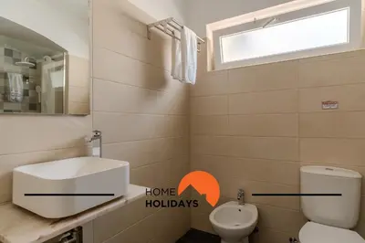 a bathroom with a sink and a toilet and a window at #265 Charming Villa Sam in Albufeira