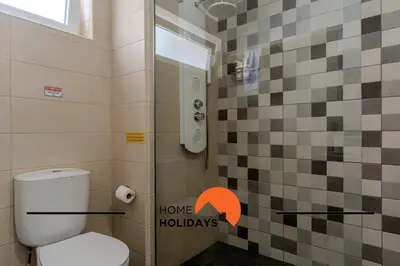 a bathroom with a toilet and a shower with a window at #265 Charming Villa Sam in Albufeira