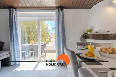 a dining room with a view of a dining table and a window at #265 Charming Villa Sam in Albufeira