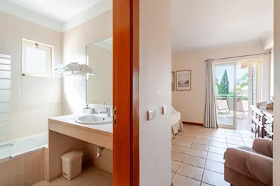 a kitchen and dining room with a table and chairs at Coastal Golf by Seareen in Vilamoura