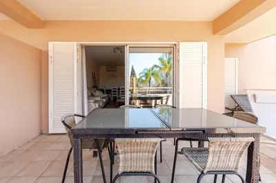 a dining room with a glass table and chairs at Coastal Golf by Seareen in Vilamoura