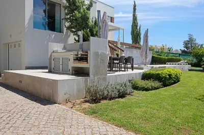 a house with a patio with a grill in a yard at Sweet Home Albufeira in Albufeira