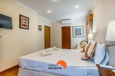 a bedroom with a bed with a home holidays sign on it at #128 Number 10 Villa by Home Holidays in Albufeira