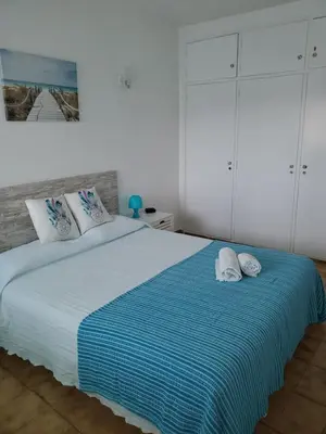 a bedroom with a large bed with two pillows at L&J Ocean View Apartment in Albufeira
