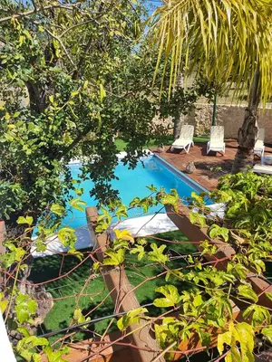a swimming pool with two loungers and a boat at Real Village in Quarteira