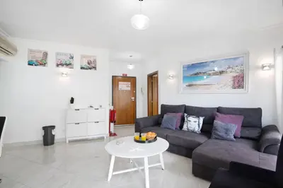 a living room with a couch and a table at Flat with Pool Marina and Sea View in Albufeira