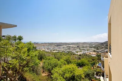 a view of a city from between two buildings at Flat with Pool Marina and Sea View in Albufeira