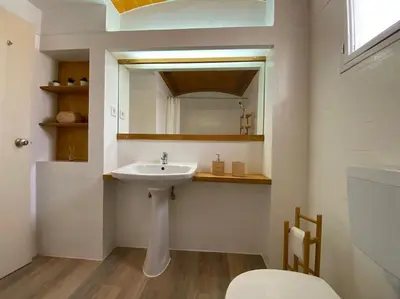 a bathroom with a sink and a mirror at Studio with great sea view, near the beach, with AC and pools in Albufeira