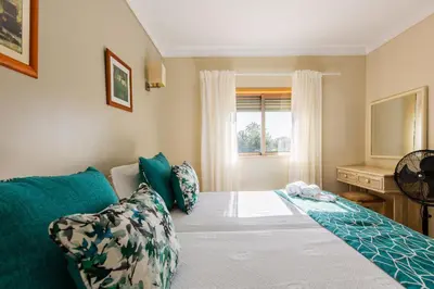 a bedroom with a bed and a window at Casa Colina in Albufeira