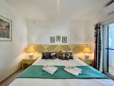 a bedroom with a large white bed with two pillows at Albufeira Balaia Golf Vilage 2 With Pool by Homing in Albufeira