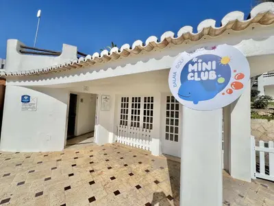 a white house with a sign in front of it at Albufeira Balaia Golf Vilage 2 With Pool by Homing in Albufeira