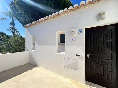 a white house with a door and a window at Albufeira Balaia Golf Vilage 2 With Pool by Homing in Albufeira