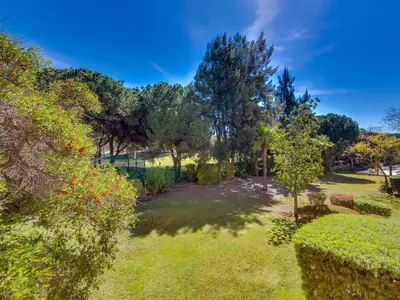 an aerial view of a garden with trees and grass at AL - Apartamento Vila Sol AG in Vilamoura
