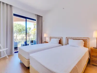 a bedroom with two beds and a balcony at AL - Apartamento Vila Sol AG in Vilamoura