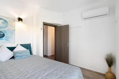 a bedroom with a bed and a painting on the wall at Villa Flora in Algoz