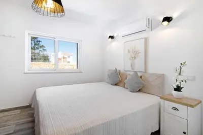 a hotel room with two beds and a closet at Villa Flora in Algoz
