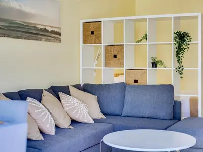 a blue couch with pillows in a living room at AL - Apartamento Falésia Terrace in Vilamoura