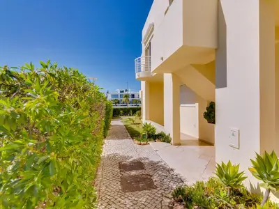 a walkway leading to a house with plants at AL - Apartamento Falésia Terrace in Vilamoura