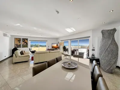 a large living room with a table and chairs at Luxury Penthouse wStunning Sea Views, walk to Galé Beach Albufeira in Albufeira