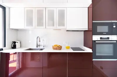a kitchen with white cabinets and a sink at Vilamoura Marina Villa in Vilamoura