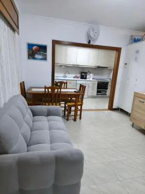 a living room with a couch and a table at Quarteira Apartamento T2 - Oceanides in Quarteira