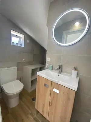 a bathroom with a sink and a toilet and a mirror at Vila Luisa Anabela Piscine et Jacuzzi in Albufeira