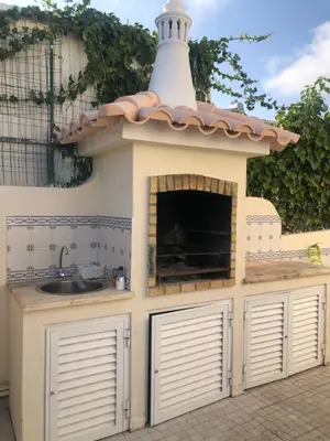 a play kitchen with a sink and a roof at Vila Luisa Anabela Piscine et Jacuzzi in Albufeira