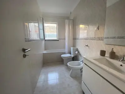 a bathroom with a toilet and a sink at Guest House in Faro