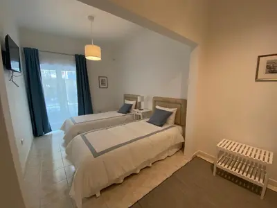 a bedroom with two beds and a window at Guest House in Faro