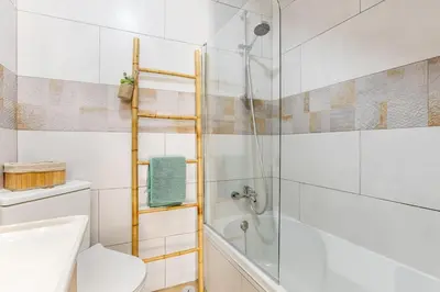 a bathroom with a shower and a toilet and a sink at Casinha da Jade in Albufeira