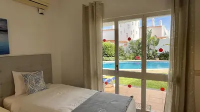 a bedroom with a bed and a view of a pool at Solar by Check-in Portugal in Albufeira